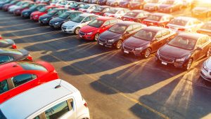 Dealer New Cars Stock. Colorful Brand New Compact Vehicles For Sale Awaiting on the Dealer Parking Lot. Car Market Business Concept.